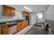 A kitchen featuring wood cabinets, black countertops, and stainless steel appliances at 5053 18Th St, Zephyrhills, FL 33542