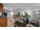 Open-concept kitchen to living area featuring dark wood furniture and black appliances at 5053 18Th St, Zephyrhills, FL 33542