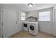 Well-lit laundry room with modern washer and dryer units at 5053 18Th St, Zephyrhills, FL 33542