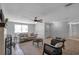 Open-concept living room with neutral decor, tile flooring, and a cozy seating area at 5053 18Th St, Zephyrhills, FL 33542