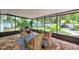 Patio with brick pavers, a couch, and two chairs overlooking the landscaped backyard at 5053 18Th St, Zephyrhills, FL 33542