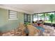 Relaxing screened-in patio with brick pavers and garden views at 5053 18Th St, Zephyrhills, FL 33542