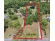 Aerial view showcases acreage with pond and wooded areas, outlining property boundaries at 5106 Five Acre Rd, Plant City, FL 33565