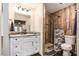 Updated bathroom featuring a stone shower, modern vanity, and stylish fixtures at 5106 Five Acre Rd, Plant City, FL 33565