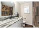 This bathroom features stone and wood accents in the shower and granite countertops at 5106 Five Acre Rd, Plant City, FL 33565