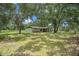 Beautiful home nestled on a sprawling green lawn with mature trees, offering a serene setting at 5106 Five Acre Rd, Plant City, FL 33565