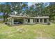 Charming home exterior with a carport and a lush green lawn at 5106 Five Acre Rd, Plant City, FL 33565