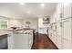 Bright kitchen boasts granite countertops, white cabinetry, wood flooring and modern appliances at 5106 Five Acre Rd, Plant City, FL 33565
