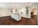 Bright, open kitchen featuring a central island, white cabinetry, and views of the living area at 5106 Five Acre Rd, Plant City, FL 33565