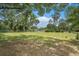 Expansive lot with lush green grass and mature trees on a sunny day at 5106 Five Acre Rd, Plant City, FL 33565