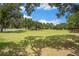 Large lot with lush green grass and shade trees, perfect for building or recreation at 5106 Five Acre Rd, Plant City, FL 33565