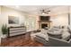 The living room features a stone fireplace, wood flooring and comfortable seating at 5106 Five Acre Rd, Plant City, FL 33565