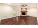 Spacious living room showcasing a stone fireplace, wood flooring, and ample natural light at 5106 Five Acre Rd, Plant City, FL 33565