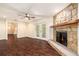 This open-concept living room features a stone fireplace and wood floors at 5106 Five Acre Rd, Plant City, FL 33565