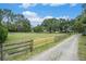 Expansive acreage features lush green pasture, mature trees, and fencing; ideal for equestrian pursuits at 5106 Five Acre Rd, Plant City, FL 33565