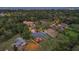 An aerial view of a beautiful single Gathering home in a quiet suburban neighborhood surrounded by trees at 512 Creekside Ct, Safety Harbor, FL 34695