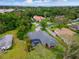 An aerial view of a beautiful single Gathering home with a screened in pool and lush greenery at 512 Creekside Ct, Safety Harbor, FL 34695