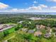 Aerial view of a home with a pool, surrounded by lush greenery, and a scenic view of the bay at 512 Creekside Ct, Safety Harbor, FL 34695