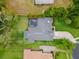 Bird's eye view of private residence with in-ground pool surrounded by lush green backyard and mature landscaping at 512 Creekside Ct, Safety Harbor, FL 34695