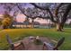 Backyard with large trees, fire pit, and chairs create a relaxing outdoor living space at 512 Creekside Ct, Safety Harbor, FL 34695