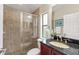 Bathroom featuring a glass-enclosed shower, granite countertop, and a window for natural light at 512 Creekside Ct, Safety Harbor, FL 34695