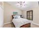 Comfortable bedroom features a ceiling fan, window with plantation shutters, and neutral decor at 512 Creekside Ct, Safety Harbor, FL 34695