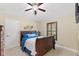 A cozy bedroom displays a comfortable bed with blue accents and a window with plantation shutters at 512 Creekside Ct, Safety Harbor, FL 34695