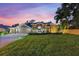 Charming single-story home with a well-manicured lawn, lush landscaping, and inviting double-door entrance at 512 Creekside Ct, Safety Harbor, FL 34695