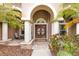 Elegant front entrance with double doors, arched entry, and manicured landscaping at 512 Creekside Ct, Safety Harbor, FL 34695