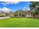 Charming home features a well-manicured lawn, mature landscaping and a double-door entryway, creating a welcoming curb appeal at 512 Creekside Ct, Safety Harbor, FL 34695