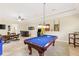 Spacious game room offers a pool table, arcade game, and wet bar for entertaining guests at 512 Creekside Ct, Safety Harbor, FL 34695