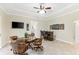 This home's game room features a wet bar, tile flooring, and a coffered ceiling with a ceiling fan at 512 Creekside Ct, Safety Harbor, FL 34695