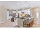 Spacious kitchen features stainless steel appliances, granite countertops, and bar seating for modern living at 512 Creekside Ct, Safety Harbor, FL 34695