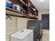 Well-organized laundry room with modern washer, dryer, shelving, and a practical sink setup at 512 Creekside Ct, Safety Harbor, FL 34695