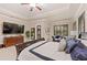 Relax in this main bedroom with tray ceiling, plantation shutters, and space for a sitting area at 512 Creekside Ct, Safety Harbor, FL 34695