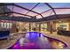 Screened pool with fountains, mood lighting, and ample patio seating for outdoor enjoyment at 512 Creekside Ct, Safety Harbor, FL 34695