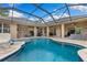 Spacious pool area with covered lanai, outdoor seating, and multiple access points to the home at 512 Creekside Ct, Safety Harbor, FL 34695