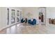 Cozy sitting room featuring tile floors, stylish furniture, and view of the pool at 512 Creekside Ct, Safety Harbor, FL 34695