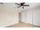Cozy bedroom boasts wood-look floors, ceiling fan and closet for ample storage at 5441 Chestnut Ridge Rd, Dade City, FL 33523