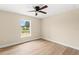 Bright bedroom features wood-look floors and a window for natural light and ventilation at 5441 Chestnut Ridge Rd, Dade City, FL 33523