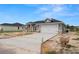 New construction showcasing a two car garage, a concrete driveway, and a well-manicured lawn at 5441 Chestnut Ridge Rd, Dade City, FL 33523
