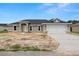 New single-story home featuring a two car garage, modern architectural details, and a well-manicured lawn at 5441 Chestnut Ridge Rd, Dade City, FL 33523