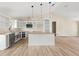 Spacious kitchen features granite countertops, white cabinetry, and a modern pendant lighting at 5441 Chestnut Ridge Rd, Dade City, FL 33523