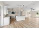 Well-lit kitchen showcases granite counters, island, and modern fixtures, perfect for cooking at 5441 Chestnut Ridge Rd, Dade City, FL 33523