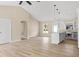 Open-concept living room boasts wood-look floors and a seamless flow to the kitchen at 5441 Chestnut Ridge Rd, Dade City, FL 33523
