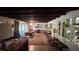 Inviting living room featuring exposed beams, natural lighting, and a view to adjacent rooms at 5719 13Th E St, Bradenton, FL 34203