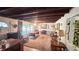 Cozy living room with exposed beam ceiling, large windows, and a comfortable seating area at 5719 13Th E St, Bradenton, FL 34203