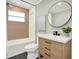 Well-lit bathroom with a modern vanity, bathtub, and stylish fixtures at 6220 Pershing Ne St, St Petersburg, FL 33702