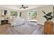 This bedroom features a ceiling fan, french doors to a deck, and wood-look floors at 6220 Pershing Ne St, St Petersburg, FL 33702