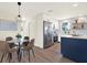 Bright eat-in kitchen boasts stainless steel appliances, shaker cabinets, and a blue island at 6220 Pershing Ne St, St Petersburg, FL 33702